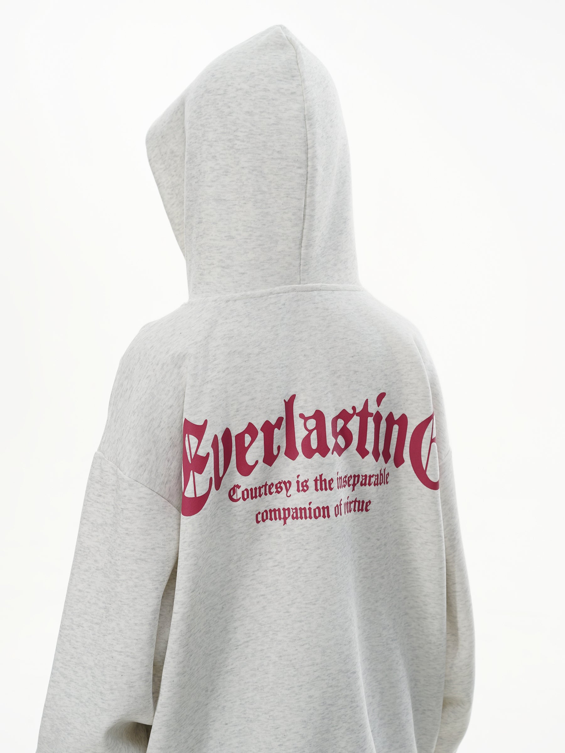 Back view of female model wearing Heather Grey hoodie showing the Everlasting slogan