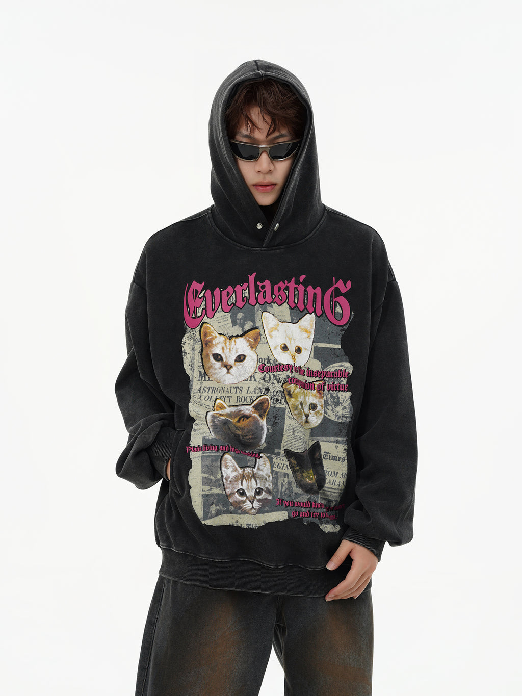 Male model wearing oversized vintage washed black cat hoodie in grunge streetwear style