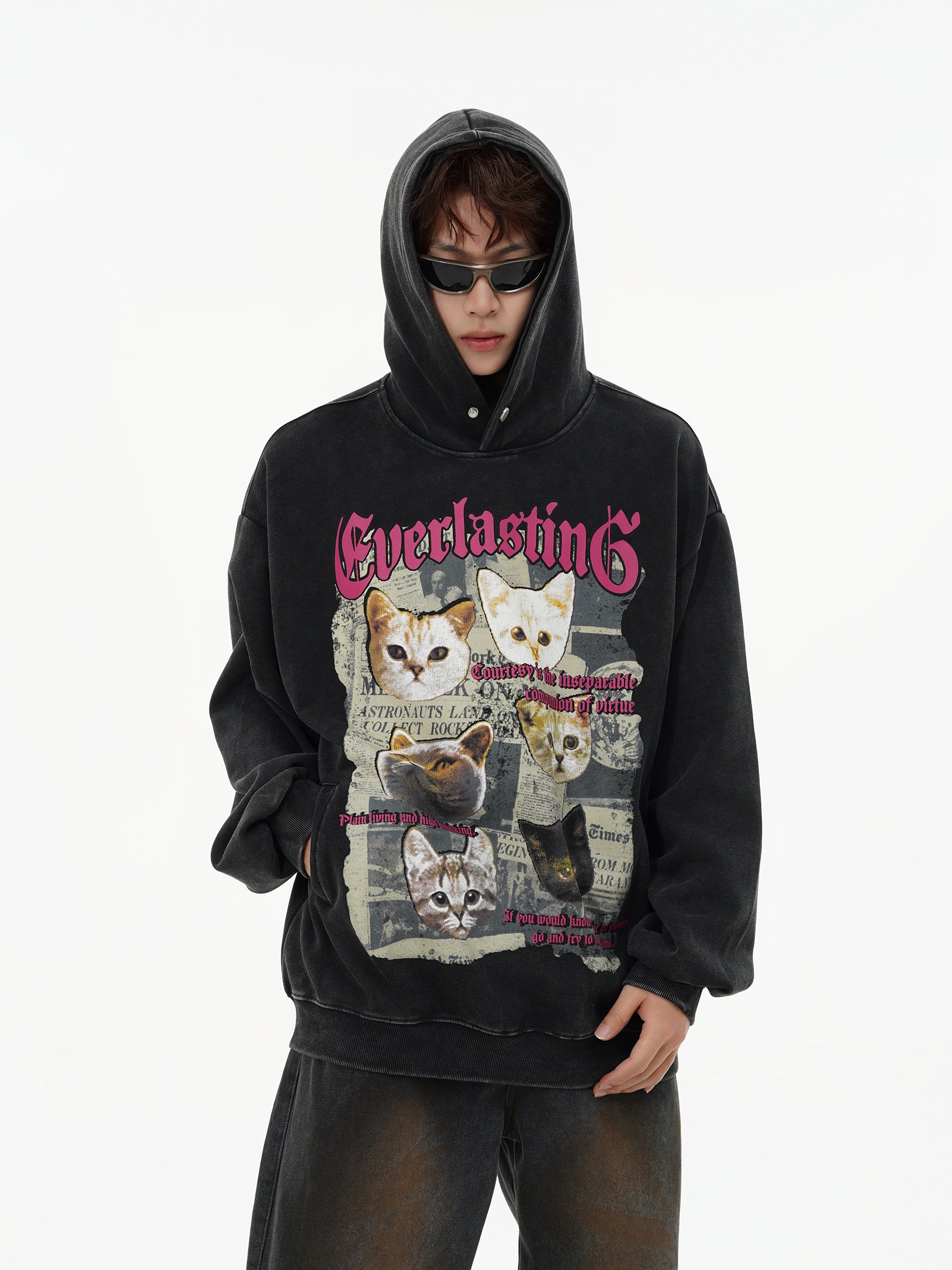 Male model wearing oversized vintage washed black cat hoodie in grunge streetwear style
