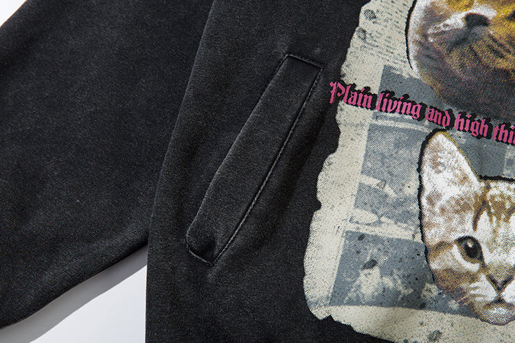 Kangaroo pocket detail and cat graphic print on washed black cotton hoodie