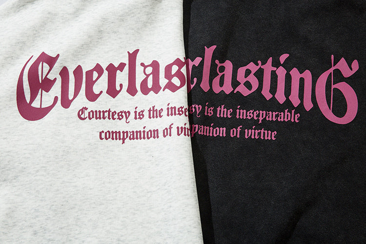 Fabric comparison of Heather Grey and Vintage Washed Black cotton blend with pink gothic text