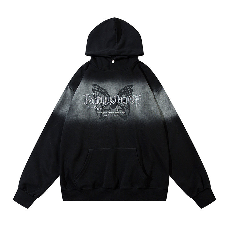 Front view of oversized black and grey gradient hoodie featuring a large gothic butterfly graphic and snap-button neckline.