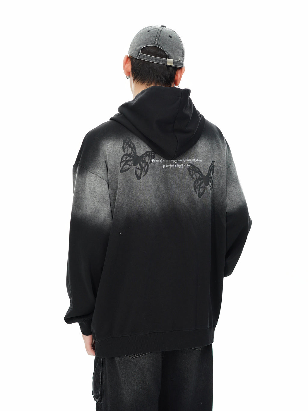Back view of the gradient hoodie showing two butterfly graphics on the shoulders worn by a male model.