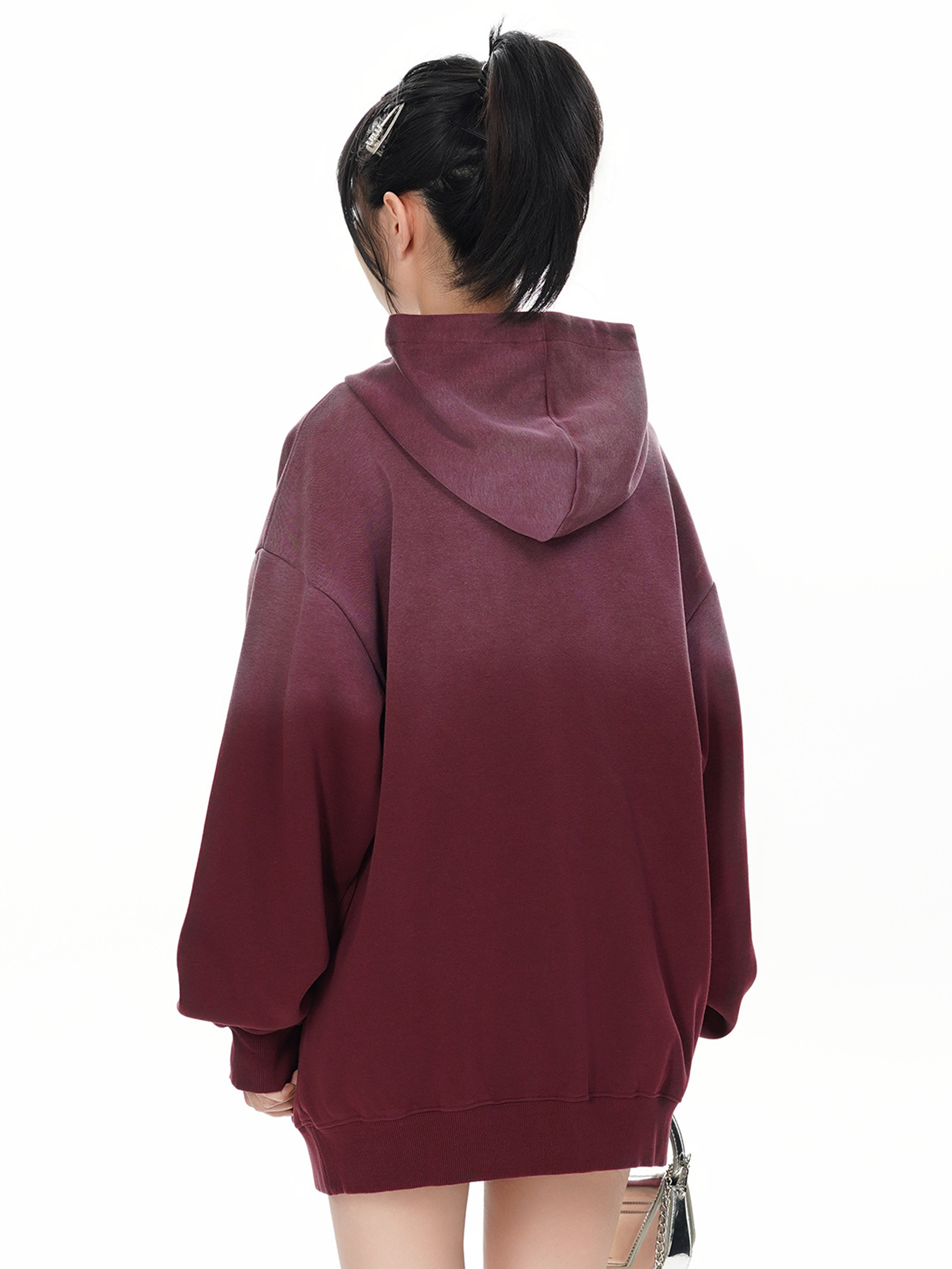 Back view of female model wearing loose fit wine red gradient hoodie
