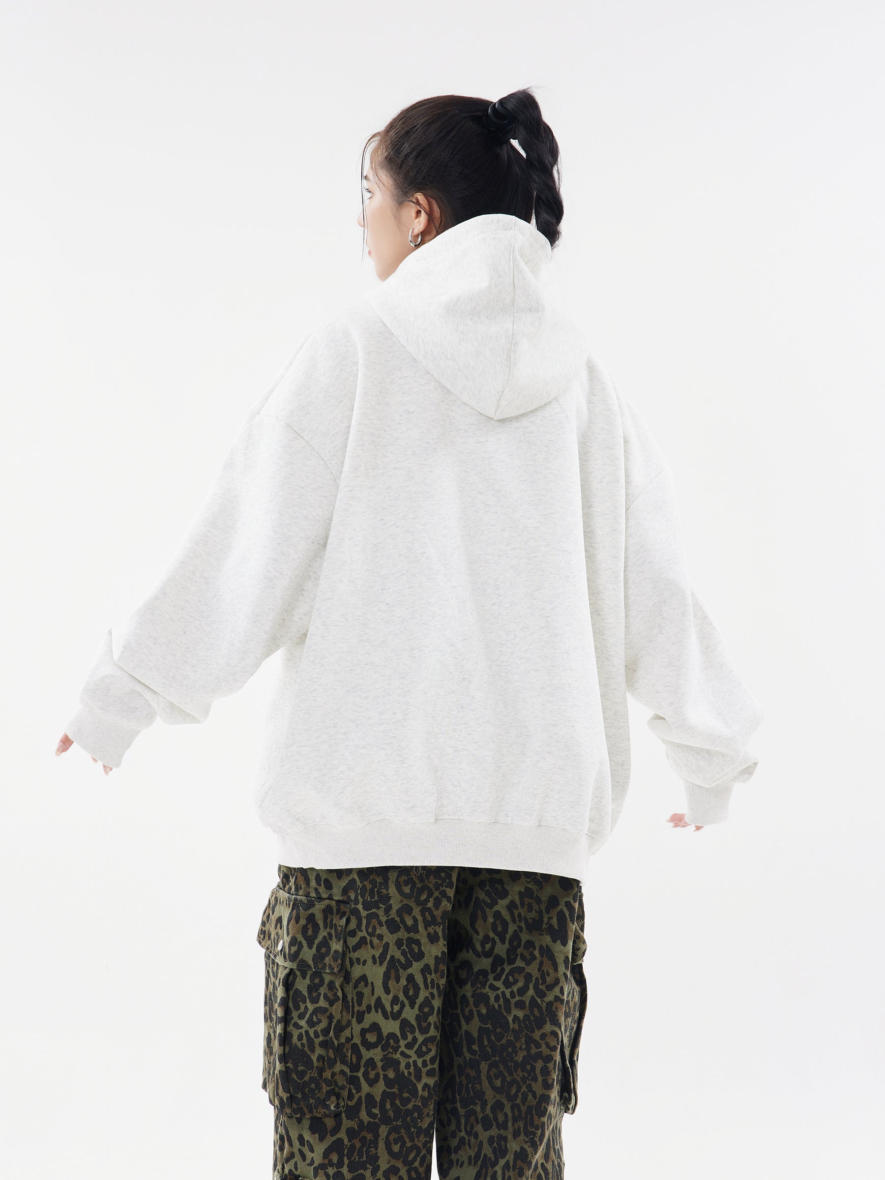Back view of model wearing Oatmeal Heather pullover hoodie, showcasing the loose and comfortable silhouette.