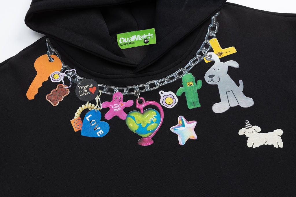 Black hoodie neckline featuring a colorful faux chain necklace print with cute charms like keys, hearts, and dogs.
