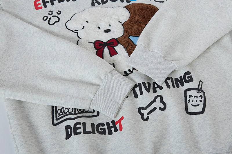 Detail of ribbed sleeve cuff on grey hoodie with text graphic near the wrist.