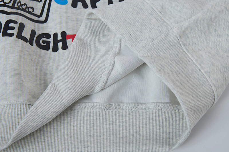 Close-up of hidden side seam pocket and soft interior fabric on grey hoodie.