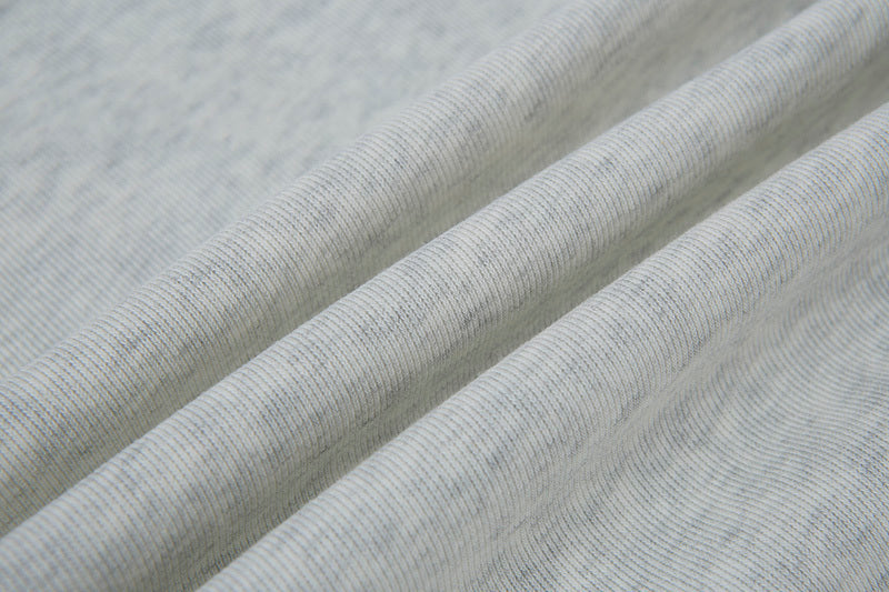 Close-up texture of heather grey cotton blend fabric showing soft knit weave.