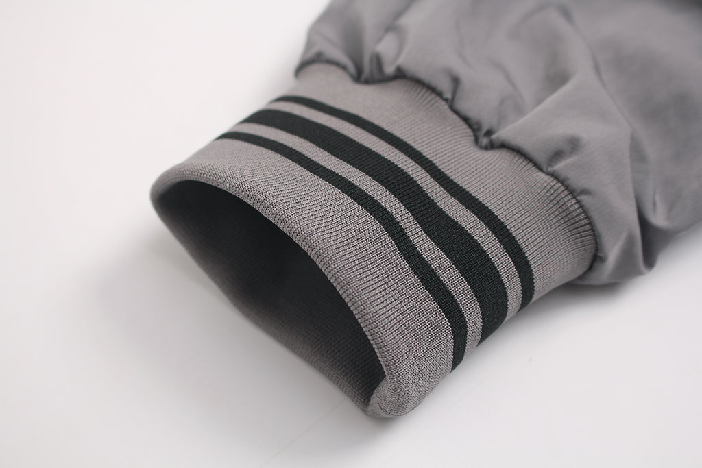 Striped ribbed cuff detail on retro sports jacket.