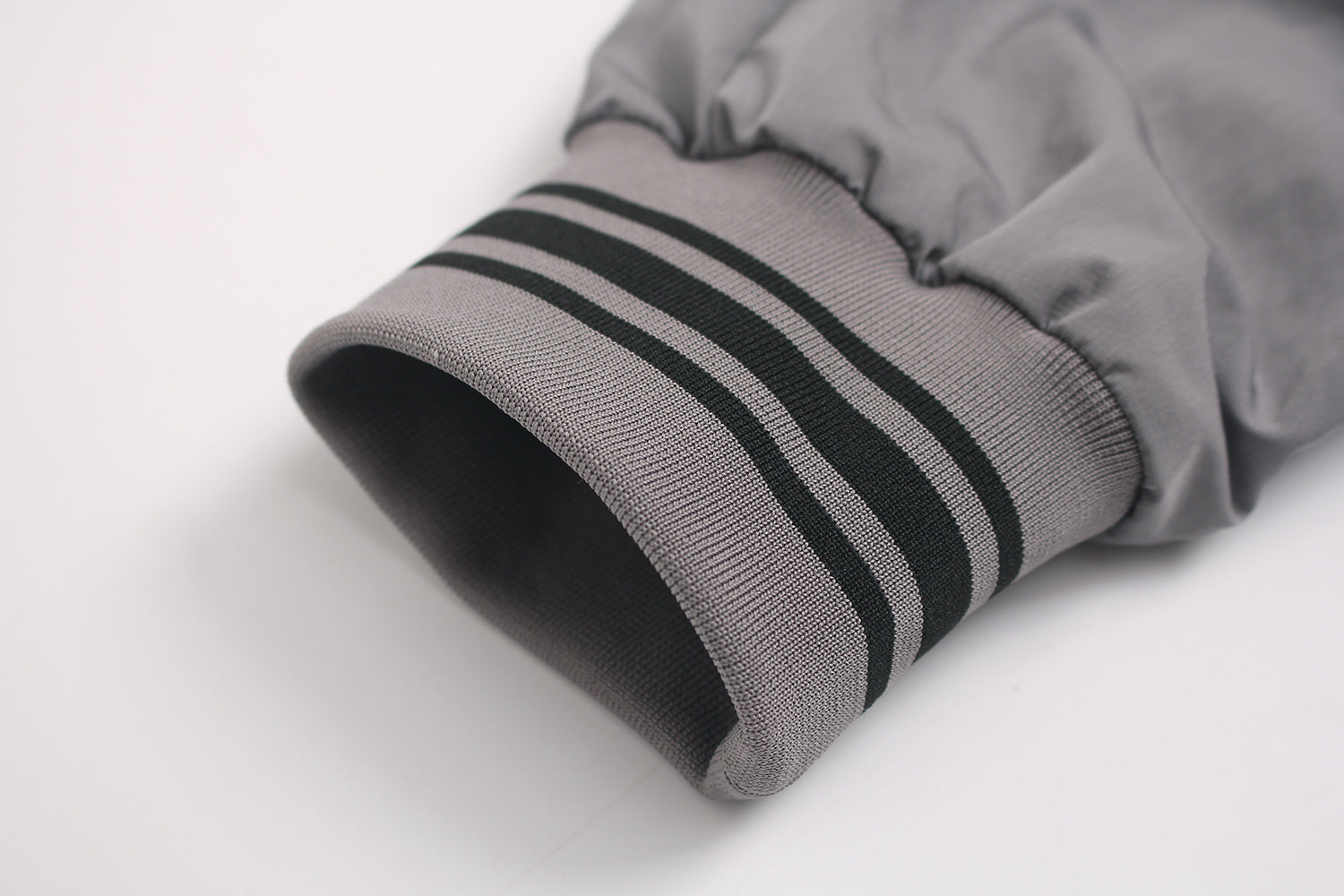 Striped ribbed cuff detail on retro sports jacket.