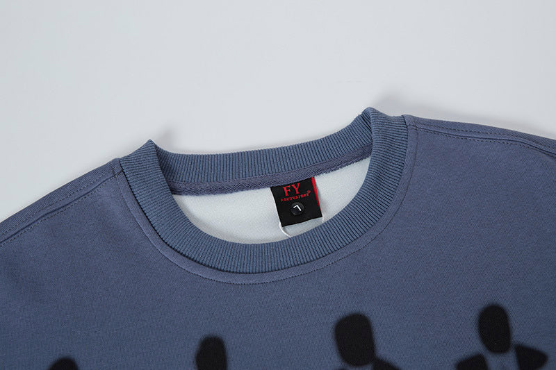 Blue sweatshirt with a brand label on a light gray background