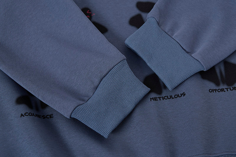 Close-up of a blue sweatshirt with text on the cuffs