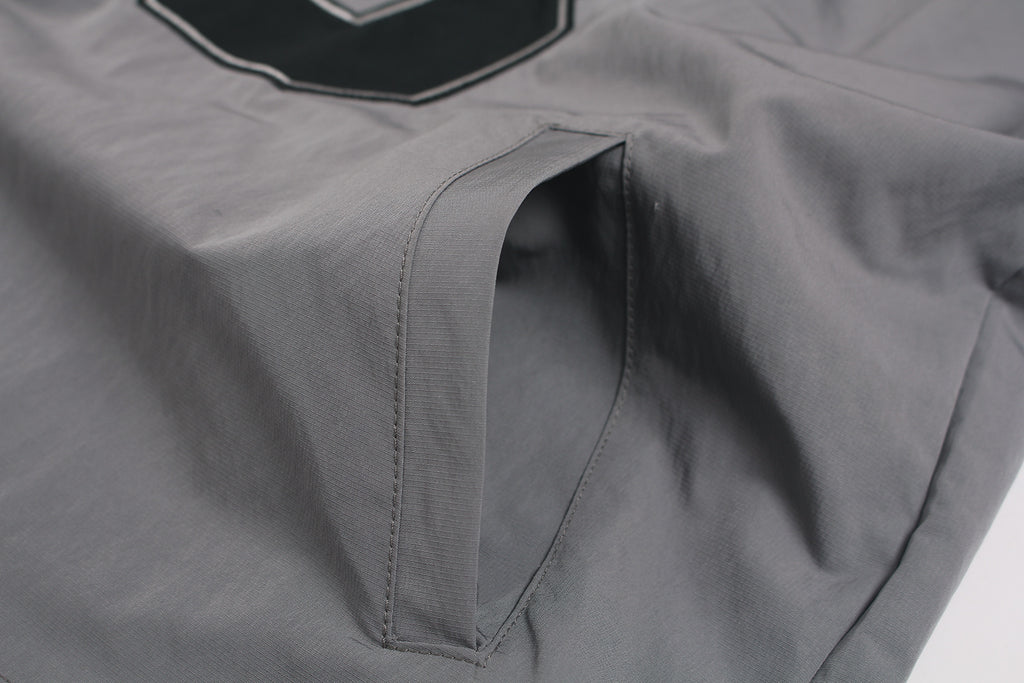 Side pocket detail on grey outdoor hiking jacket.