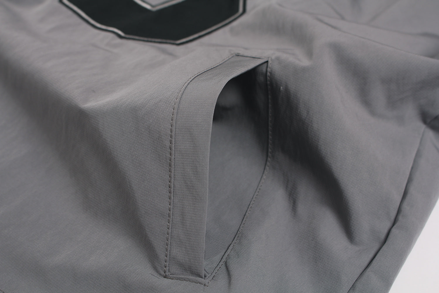 Side pocket detail on grey outdoor hiking jacket.